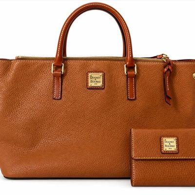 Sale Photo Thumbnail #10: Dooney & Bourke cognac pebble grain leather handbag with double handles and gold-tone hardware, accompanied by a matching bifold wallet.