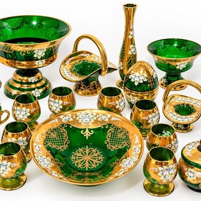 Sale Photo Thumbnail #23: Collection of Venetian Bohemian-style emerald green glass tableware featuring heavy gold gilding and hand-painted enamel floral decorations, including bowls, goblets, baskets, and a decanter.