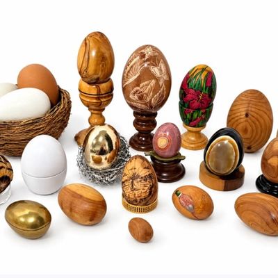 Sale Photo Thumbnail #2: Eclectic collection of decorative eggs, featuring carved wood, polished stone, hand-painted designs, metal, and natural specimens with displays.
