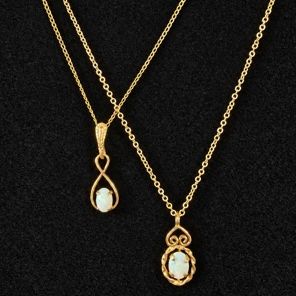 Sale Photo Thumbnail #19: Pair of gold-tone chain necklaces featuring oval opal cabochon pendant drops in delicate filigree and scrollwork settings.