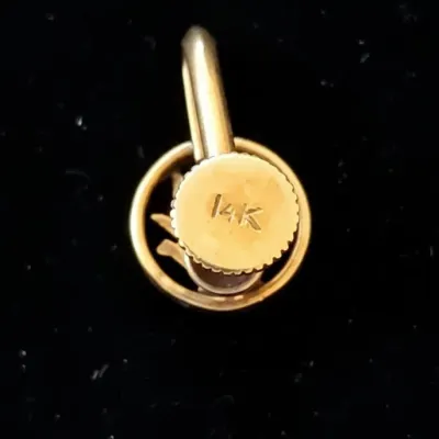Sale Photo Thumbnail #698: Close-up of a 14K gold screw-back earring finding against a dark background, showing a crisp hallmark stamp.