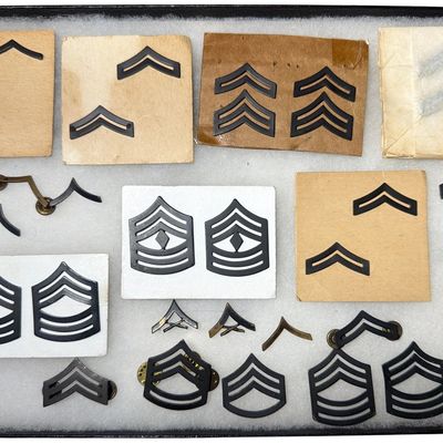 Sale Photo Thumbnail #554: A Collection of U.S. Army Subdued and Polished Metal Enlisted Rank Insignia