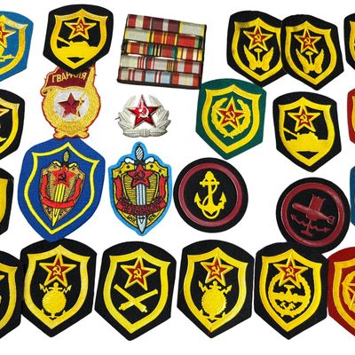 Sale Photo Thumbnail #533: A Collection of Soviet Russian Military Insignia Including Sleeve Patches, a Hat Cockade, and a Medal Ribbon Bar