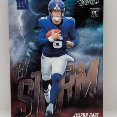Sale Photo Thumbnail #255: Panini Absolute Football Jaxson Dart 'By Storm' rookie card featuring a stormy background design and New York Giants uniform.