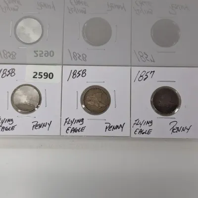 Sale Photo Thumbnail #915: Set of three U.S. Flying Eagle small cents, including two dated 1858 and one dated 1857, each housed in protective cardboard coin flips.