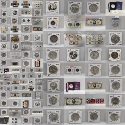 Sale Photo Thumbnail #5: A photo grid displaying various collectible coins and paper currency, including Morgan and Peace silver dollars, U.S. mint sets, and bullion.