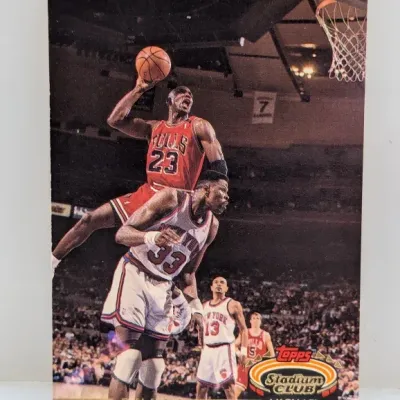 Sale Photo Thumbnail #580: 1992-93 Topps Stadium Club Michael Jordan #1 basketball trading card featuring an action shot against Patrick Ewing.