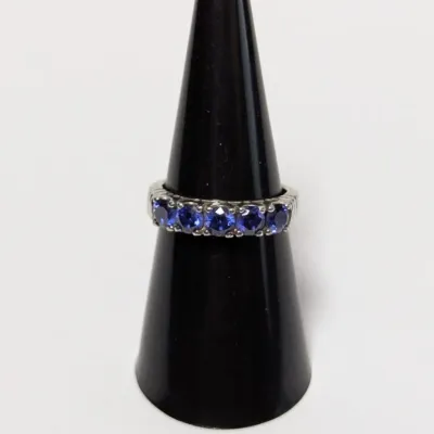 Sale Photo Thumbnail #802: Sterling silver or white gold ring featuring a row of five prong-set round blue sapphires or tanzanite stones.