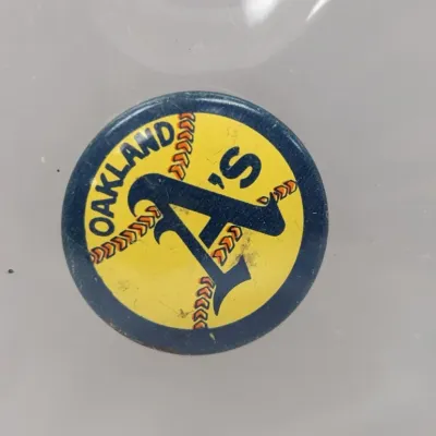 Sale Photo Thumbnail #163: Vintage Oakland A's pinback button featuring the classic team logo on a yellow and green background.