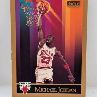 Sale Photo Thumbnail #673: 1990-91 SkyBox Michael Jordan Chicago Bulls basketball card #41 featuring a gold border and colorful graphic background.
