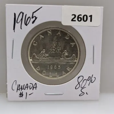 Sale Photo Thumbnail #926: 1965 Canadian silver dollar coin in a cardboard flip holder, featuring the voyageur design.