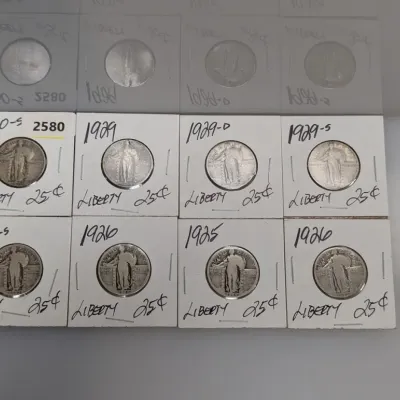 Sale Photo Thumbnail #905: Collection of Standing Liberty US quarter dollars dated from 1925 to 1930, individually stored in labeled cardboard coin flips.