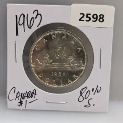 Sale Photo Thumbnail #923: 1965 Canadian silver dollar featuring the Voyageur reverse design, mounted in a cardboard coin holder.