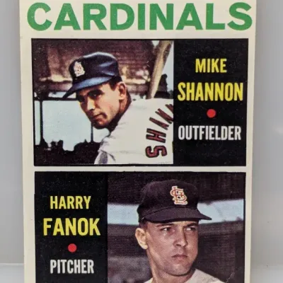 Sale Photo Thumbnail #582: 1964 Topps #167 Cardinals Rookie Stars baseball card featuring Mike Shannon and Harry Fanok. Card shows slight corner wear and good centering.