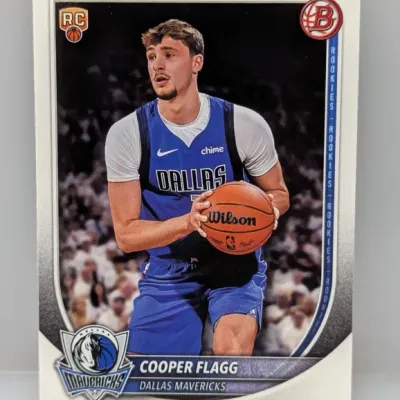 Sale Photo Thumbnail #304: Cooper Flagg Bowman rookie basketball trading card in good condition, featuring him in a Dallas Mavericks uniform holding a Wilson basketball.