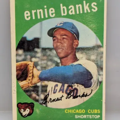 Sale Photo Thumbnail #95: 1959 Topps Ernie Banks #350 Chicago Cubs baseball card featuring a circular portrait and green background.