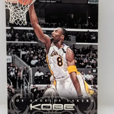 Sale Photo Thumbnail #277: Kobe Bryant Panini trading card featuring him dunking in his Los Angeles Lakers jersey.