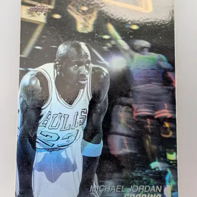 Sale Photo Thumbnail #404: 1991 Upper Deck Michael Jordan 'Scoring' Hologram trading card #H5, featuring a black-and-white portrait over a holographic action shot.