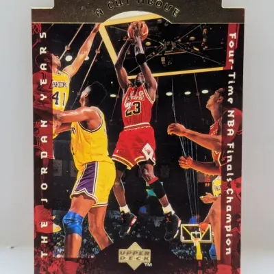 Sale Photo Thumbnail #619: 1996-97 Upper Deck 'A Cut Above' Michael Jordan die-cut trading card, featuring gold foil accents and die-cut top edge.