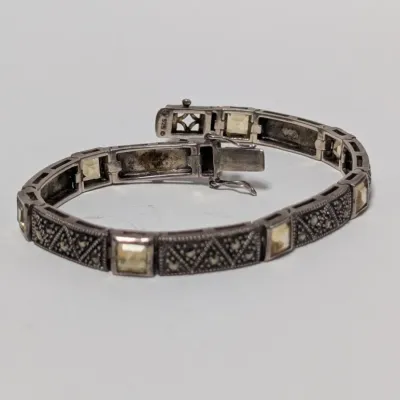 Sale Photo Thumbnail #814: Vintage Art Deco style sterling silver tennis bracelet featuring marcasite and light yellow square-cut gemstone links.