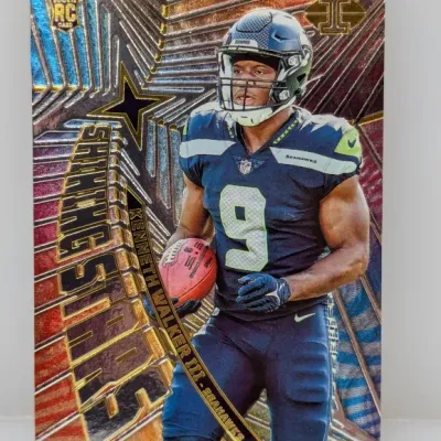 Sale Photo Thumbnail #306: 2022 Panini Illusions Kenneth Walker III 'Shining Stars' RC trading card in excellent condition.