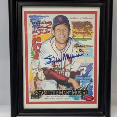 Sale Photo Thumbnail #24: Framed autographed Stan Musial commemorative print featuring various career highlights, presented in a molded black wood frame.