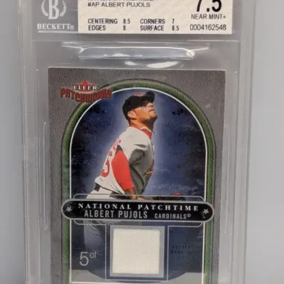 Sale Photo Thumbnail #15: Beckett graded 7.5 Near Mint+ 2004 Fleer Patchworks National Patchtime Albert Pujols game-worn jersey swatch trading card.