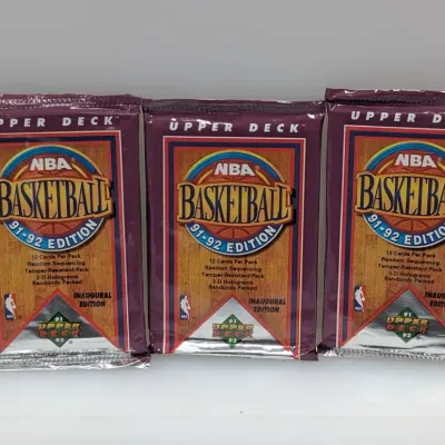 Sale Photo Thumbnail #453: Trio of unopened 1991-92 Upper Deck NBA Basketball Inaugural Edition wax packs, each containing 12 cards.