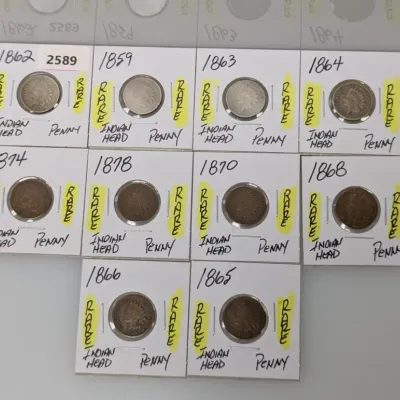 Sale Photo Thumbnail #914: Collection of ten 19th-century US Indian Head pennies in cardboard coin flips, dated 1859 through 1878.