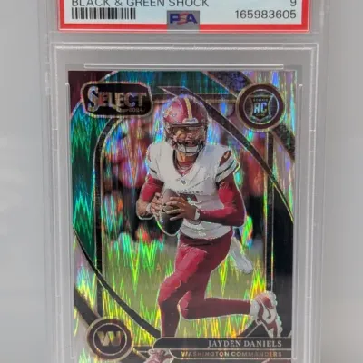 Sale Photo Thumbnail #113: PSA-graded Mint 9 copy of a 2024 Panini Select Jayden Daniels Black & Green Shock rookie card #217.