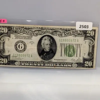 Sale Photo Thumbnail #828: Series of 1928B $20 Federal Reserve Note featuring Andrew Jackson, enclosed in a protective plastic sleeve.