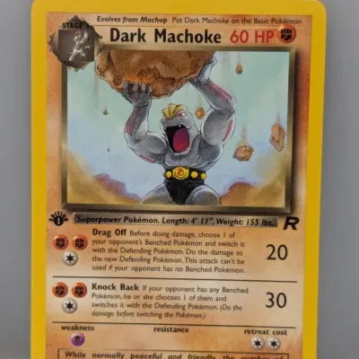 Sale Photo Thumbnail #550: 1st Edition Dark Machoke 40/82 Pokémon card from the 2000 Team Rocket expansion set, illustrated by Mitsuhiro Arita.