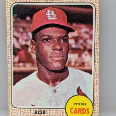 Sale Photo Thumbnail #554: 1968 Topps #100 Bob Gibson baseball card featuring the St. Louis Cardinals pitcher, showing light edge and corner wear.