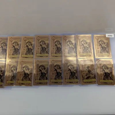 Sale Photo Thumbnail #827: Collection of modern Goldback gold foil notes displayed in protective plastic sleeves.