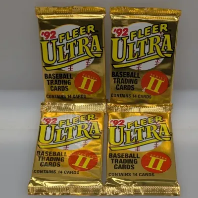 Sale Photo Thumbnail #415: Four unopened wax packs of 1992 Fleer Ultra Series II baseball trading cards, each containing 14 cards in metallic gold foil packaging.