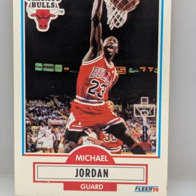 Sale Photo Thumbnail #124: 1990 Fleer Michael Jordan basketball trading card #26 featuring the Chicago Bulls guard dunking.