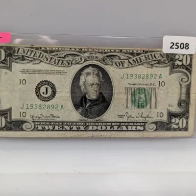 Sale Photo Thumbnail #833: Series 1950 $20 Federal Reserve Note featuring Andrew Jackson, enclosed in a protective plastic sleeve.