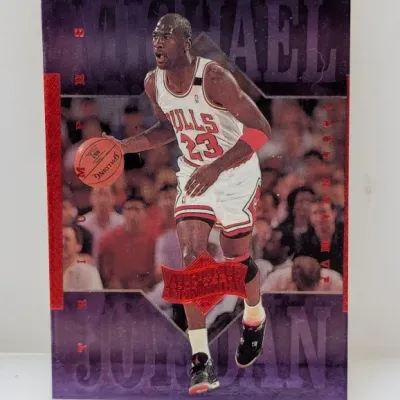 Sale Photo Thumbnail #688: 1999 Upper Deck Michael Jordan 'Athlete of the Century' basketball trading card featuring a purple metallic background and foil accents.