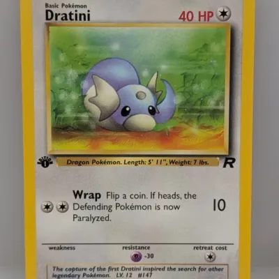 Sale Photo Thumbnail #235: 1st Edition Dratini #53/82 Pokémon trading card from the 2000 Team Rocket expansion set, illustrated by Kagemaru Himeno.