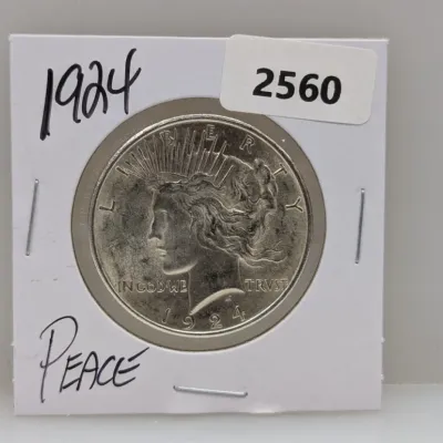 Sale Photo Thumbnail #885: 1924 Peace silver dollar coin in a cardboard flip holder.