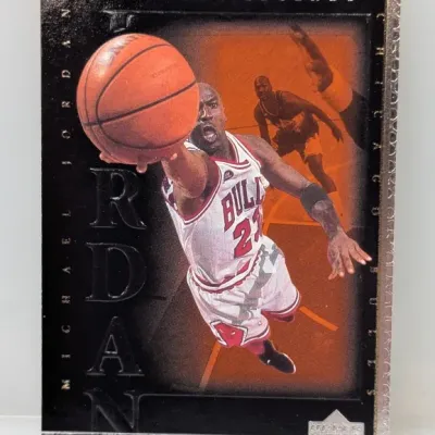 Sale Photo Thumbnail #310: 1999-00 Upper Deck NBA Legends Michael Jordan "The Best" trading card featuring a high-flying action shot of the Chicago Bulls star.