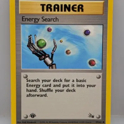 Sale Photo Thumbnail #294: 1999 Pokémon Fossil set 1st Edition Energy Search Trainer card (59/62), illustrated by Keiji Kinebuchi, in lightly played condition with clean borders.
