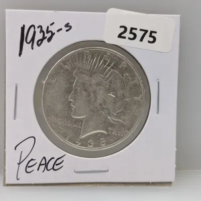 Sale Photo Thumbnail #900: 1935-S Peace silver dollar coin in a protective cardboard flip holder.