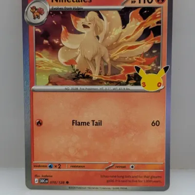 Sale Photo Thumbnail #245: Ninetales Pokémon card (010/128) featuring the 25th-anniversary Pikachu stamp icon. The card is in excellent condition with crisp edges and vibrant colors.