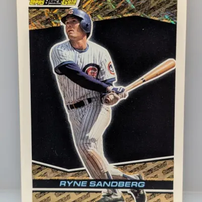 Sale Photo Thumbnail #122: 1993 Topps Black Gold Ryne Sandberg baseball card featuring a metallic gold holographic border and black background.