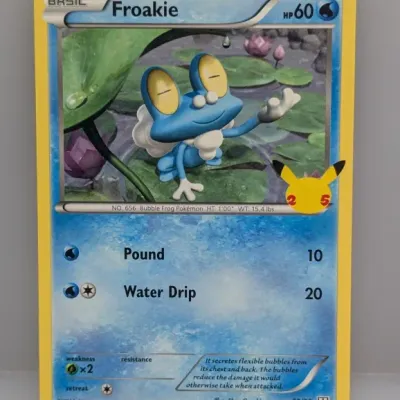 Sale Photo Thumbnail #725: Froakie Pokémon trading card from the 25th Anniversary Celebrations set, dated 2021, in good condition.