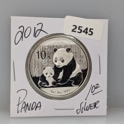 Sale Photo Thumbnail #870: 2012 Chinese Silver Panda 10 Yuan 1 oz fine silver coin in a cardboard holder.