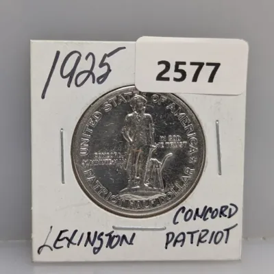 Sale Photo Thumbnail #902: 1925 Lexington-Concord Sesquicentennial silver commemorative half dollar stored in a cardboard coin flip.