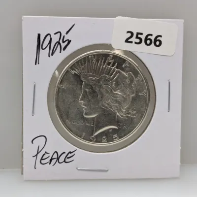 Sale Photo Thumbnail #891: 1925 Peace silver dollar coin in a cardboard flip holder labeled with lot number 2566.