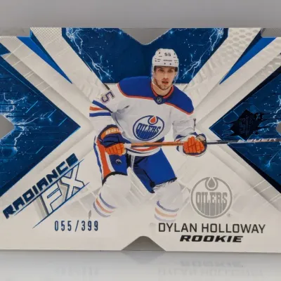 Sale Photo Thumbnail #399: SPx Radiance FX Dylan Holloway rookie hockey trading card, serial numbered 055/399, featuring the Edmonton Oilers player in a blue and white die-cut design.